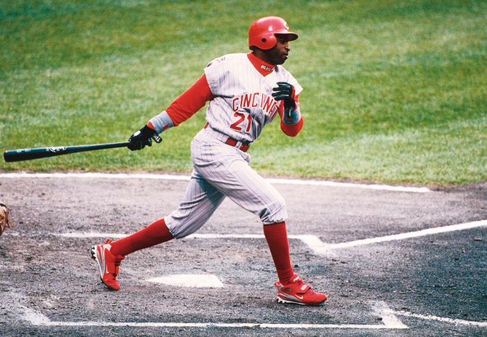 Deion Sanders swings during a baseball game.